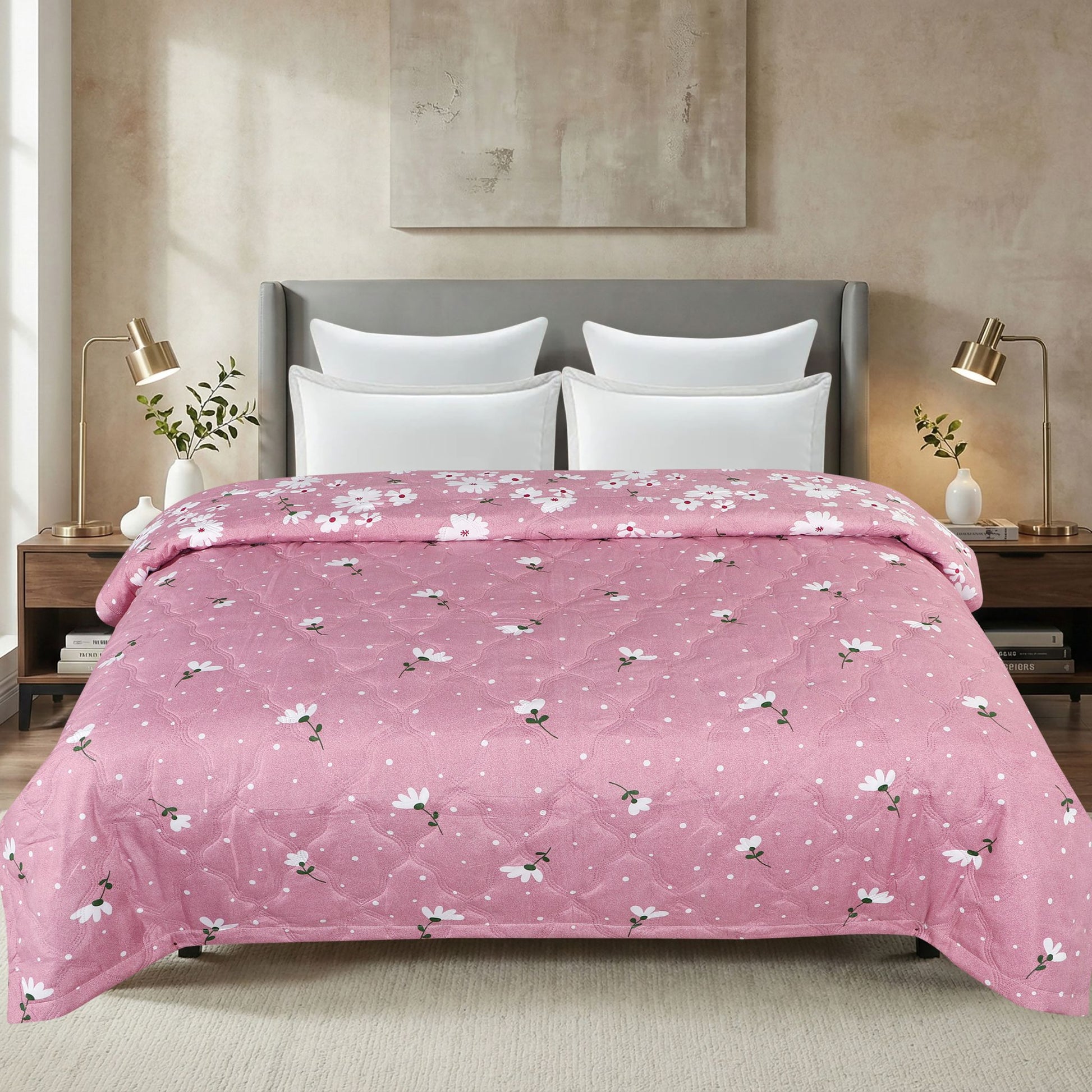 Bed with pink floral comforter in a bedroom setting
