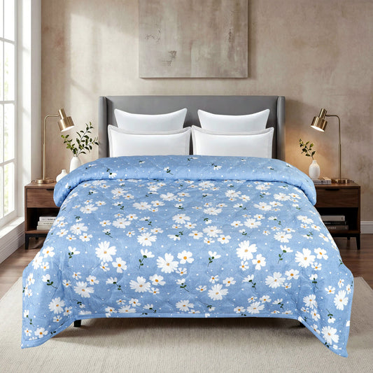 Blue floral comforter on a bed in a bedroom setting